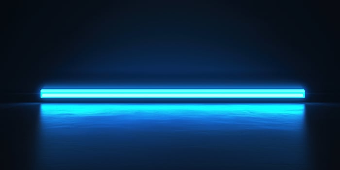 Bright blue neon light illuminating dark room with reflective floor photo
