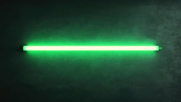 Green neon tube light illuminating dark concrete wall photo