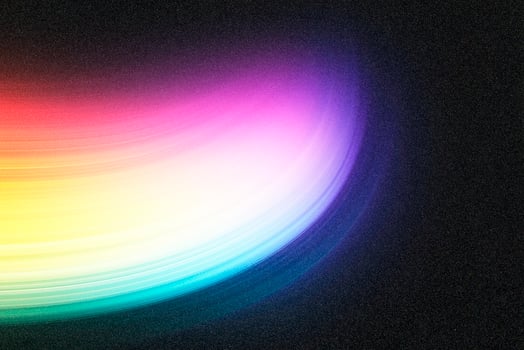 Colorful light trails creating abstract swirling pattern on dark background photo