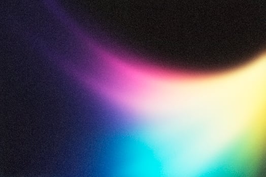 Colorful light leak creating a spectrum on dark background photo
