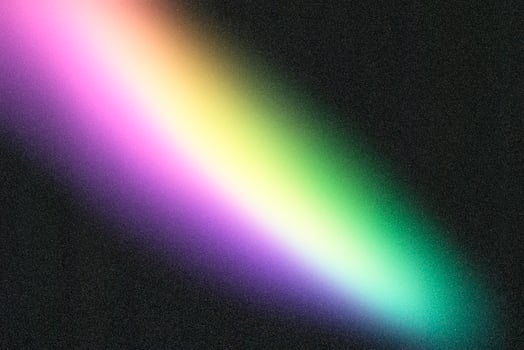 Diagonal rainbow gradient fading on grainy black background photo