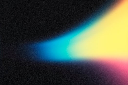 Light beam crossing dark background with blue, green, yellow and pink color gradient photo