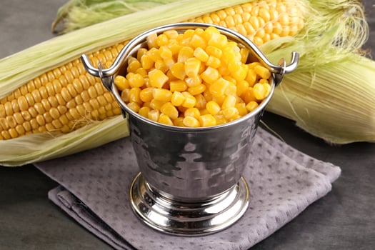 Corn in a metal bucket with a napkin photo