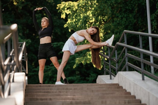 Getting ,ready, warm ,up ,,exercises. Two sportive women are outdoors together photo