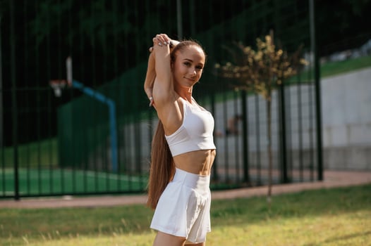 Posing, relaxed. Young skinny ,,fitness ,woman is outdoors photo