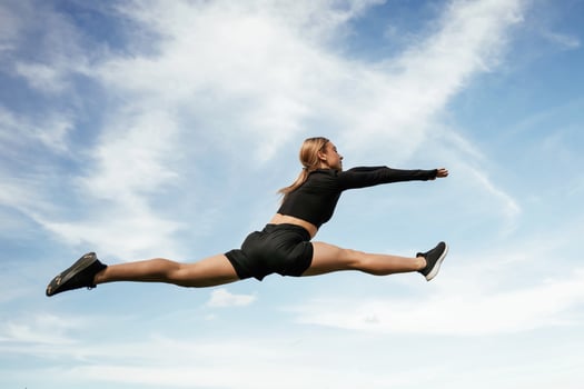 Crazy,, tricks in the air. Beautiful ,fitness woman in sport clothes is outdoors photo