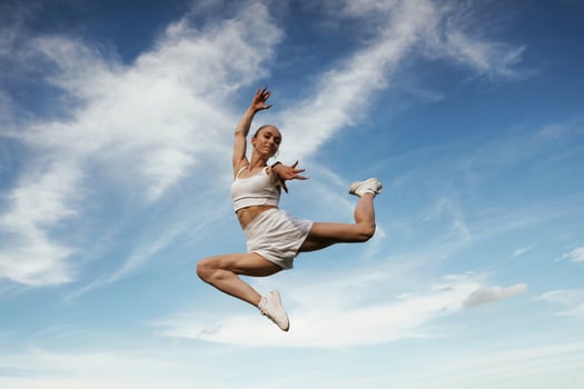 Beautiful sky ,at, background. Young skinny fitness woman is outdoors photo