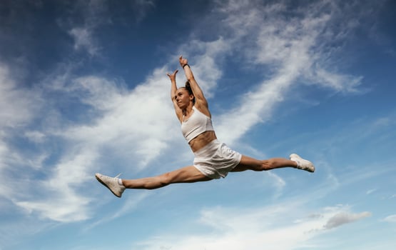 Beautiful sky, at ,background. Young skinny fitness woman is outdoors photo