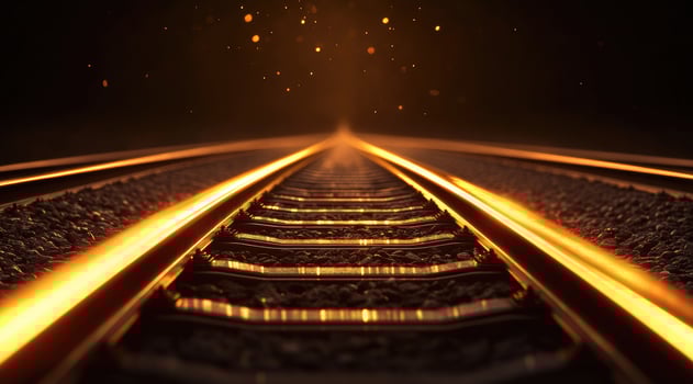 Golden railway tracks, leading into the dark photo