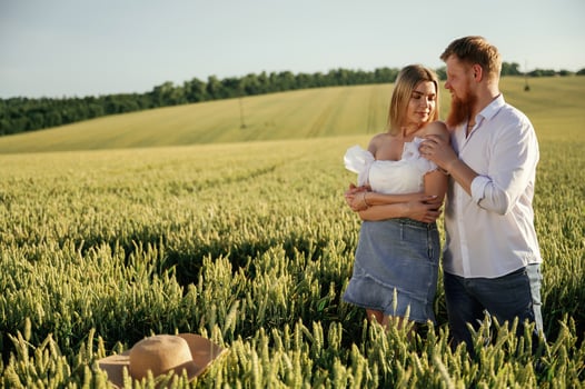 Summertime ,,wellness, happiness. Lovely couple are on the green agricultural field together photo