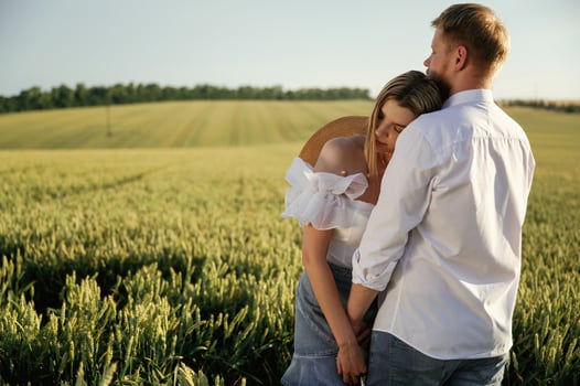 Lovely ,couple are on the green agricultural field together photo