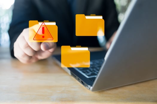 Hand touch a virtual folder with alert symbol. Cyberattacks on computer networks. photo