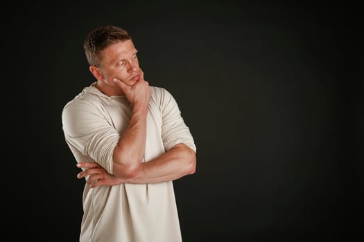 Do ,you have any idea, standing and thinking. Man is against background in the studio photo