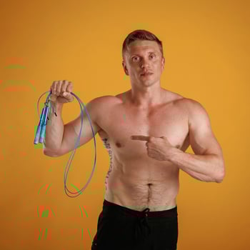 Blue,, jumping rope, fitness conception. Man is against background in the studio photo