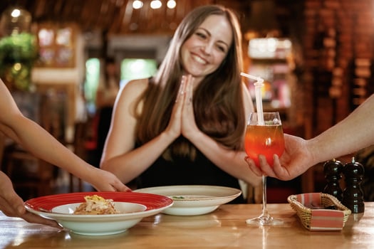 The waiters brought ,the,,, food. Woman is in the restaurant photo