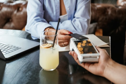 Money transfer. Woman is,, paying, for the service in the restaurant photo