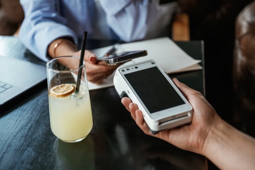 Contactless,, transfer. Woman is paying for the service in the restaurant photo