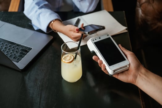 Money transfer. Woman is paying ,for the service in the restaurant photo