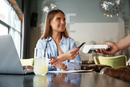 Side, view.. Woman is paying for the service in the restaurant photo