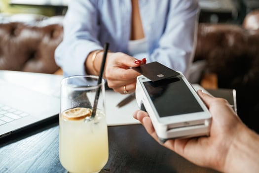 Money transfer.. Woman is paying for the service in the restaurant photo