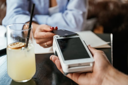 Money,, transfer. Woman is paying for the service in the restaurant photo