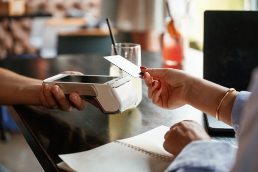 Woman is, paying for the service in the restaurant photo