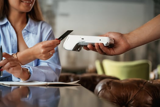 Side view. Woman, is paying for the service in the restaurant photo