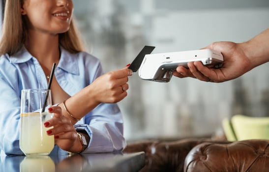 Side ,view. Woman is paying for the service in the restaurant photo