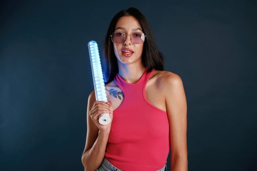 Neon lighting, equipment ,,in hands. Beautiful young woman is against background photo