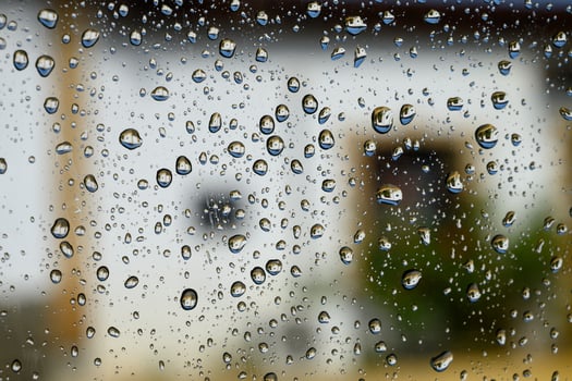 Raindrops on Car Window Glass Close-Up photo