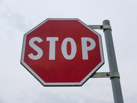 stop sign over cloudy sky photo