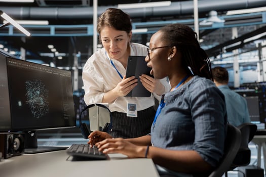 Data center technicians look at visualization on PC screen to pinpoint equipment performance issues. Server hub teamworking colleague look at data analysis graph to reduce hardware failures photo