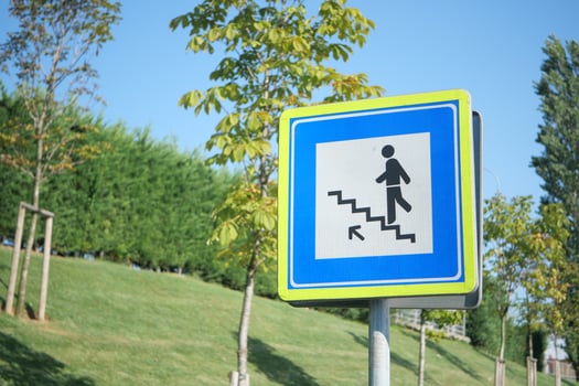 Sign indicating stairs in a public park area photo