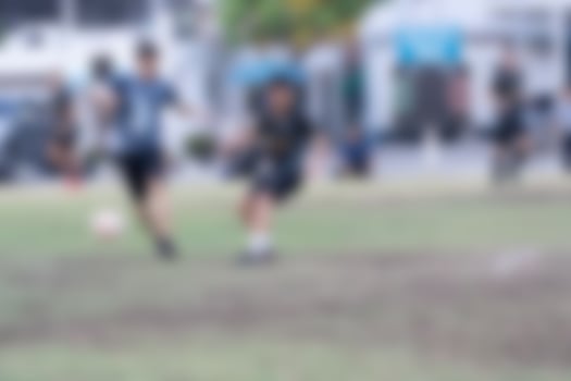 Blur of man playing soccer football at football field photo