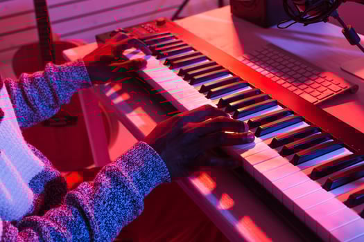 Professional african american musician recording synthesizer in digital studio at home, close-up, Music production technology concept. photo