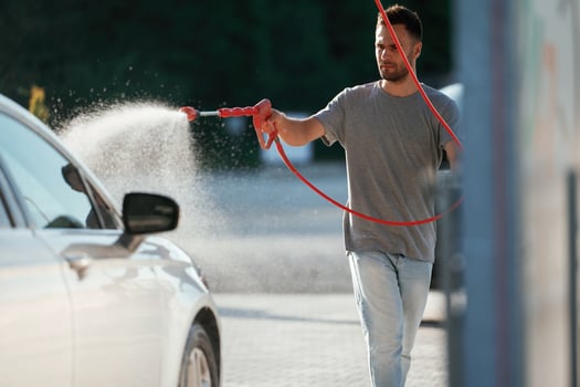 Washing ,,the, automobile. Man is with his car outdoors.. photo