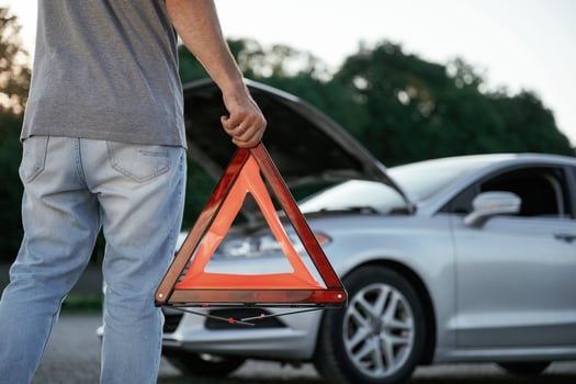 Holding red sign, broken ,,automobile... Man is with his car outdoors photo