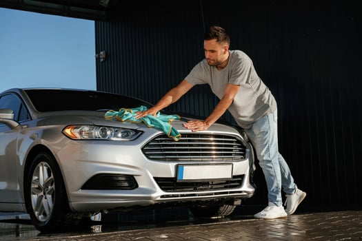 With, cloth ,in hands. Car wash. Man is with automobile outdoors photo