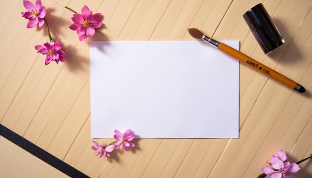 A note, pen and flowers on a wooden table photo