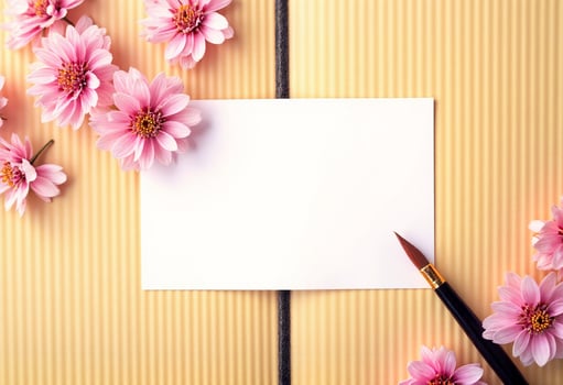 Pink flowers on a yellow background with a blank note card and a pen photo