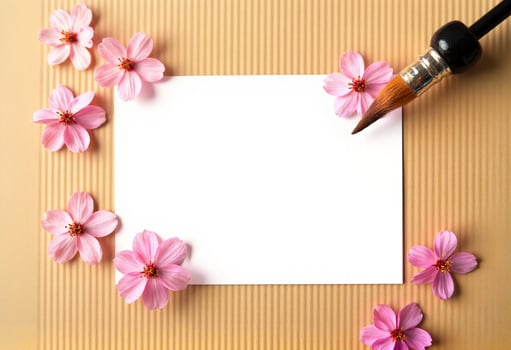 A blank paper with pink flowers on a brown background photo
