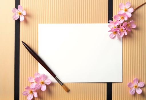 A blank paper and a brush on a wooden background photo