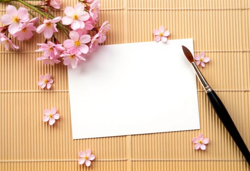 A blank note and a brush on a bamboo mat photo