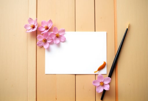 Pink flowers and a note on a wooden background photo