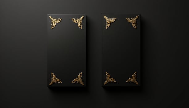 Two black boxes with gold decorations on them photo