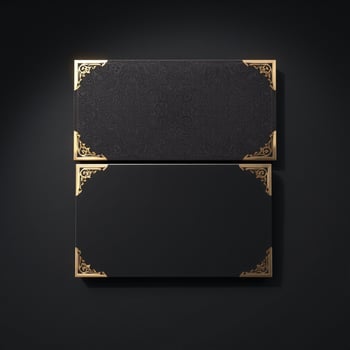 Two black and gold frames with gold trim on a black background photo
