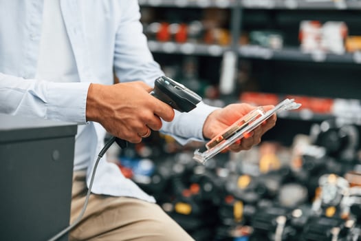 Cashier is ,at work. Man is in the hardware shop photo