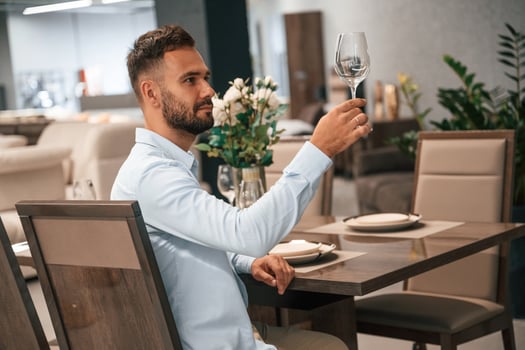 Man is ,sitting, in the restaurant with tasty alcohol drink photo