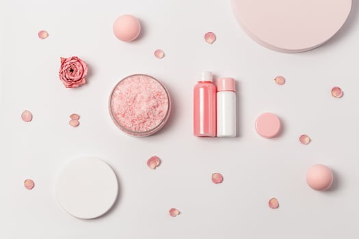Aromatic crystals of sea salt with essential oil flower of rose. Spa composition with cosmetic bathroom product top view photo