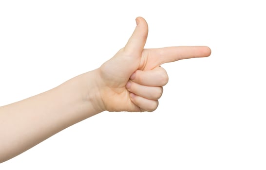 Kid hand pointing on virtual object with index finger, making gun gesture, isolated on white background, close-up photo